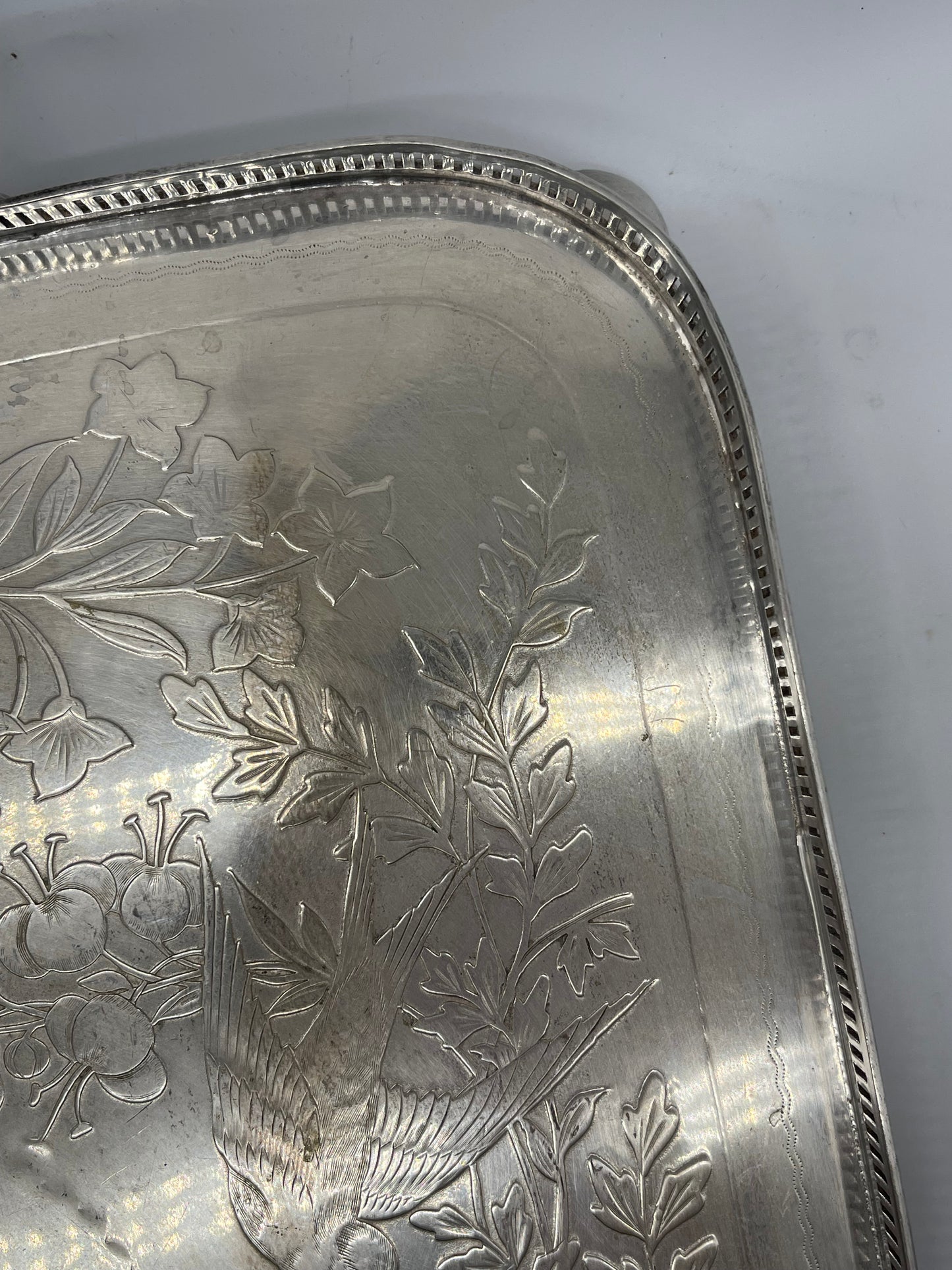 Exceptional footed silver tray with wooden serving handles and bird and floral engraving scene